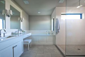 Ceiling Heigh Shower with transom window and stone tile in Custom ND Home