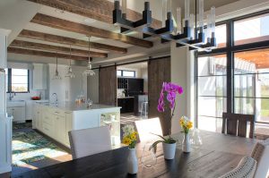 Timber beams and large windows in dining room of Fargo, ND custom home