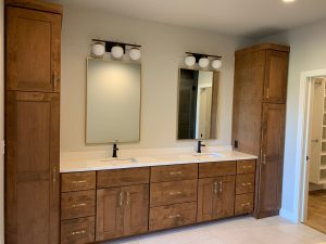 Dual bathroom vanity in custom home with gold finishings